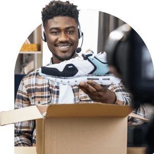 MAn smiles with sneakers
