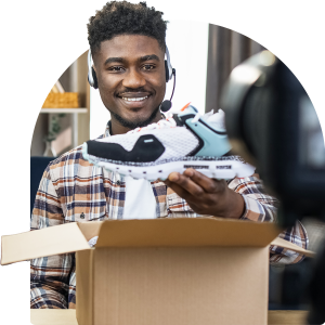 MAn smiles with sneakers