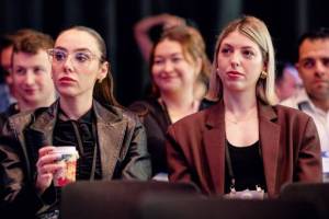 Two female audience enjoying the executive remarks